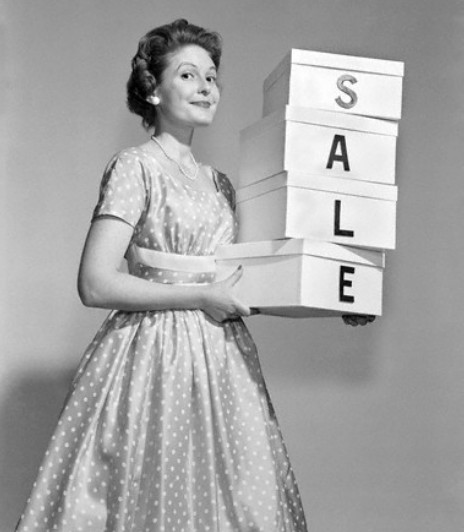 1950's woman holding shopping boxes